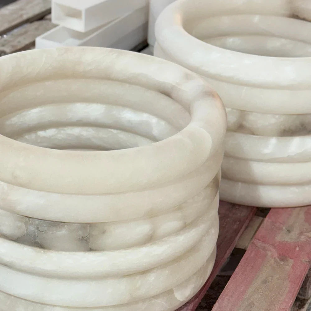 Stacked alabaster rings with creamy tones and cloud-like markings.